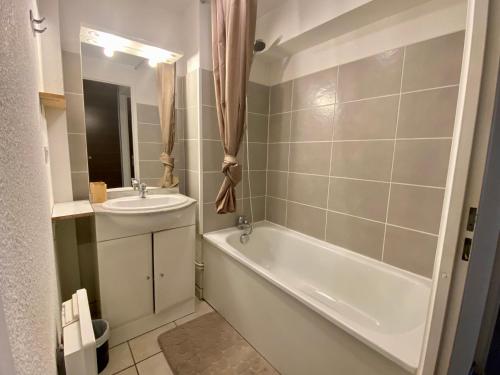une salle de bain avec une baignoire et un lavabo dans l'établissement Appartement RDC - Luz-St-Sauveur, à Luz-Saint-Sauveur