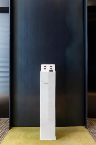 a white stand in front of a black wall at Handpicked Hotel & Collections in Seoul