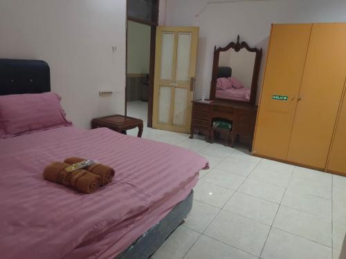 Una cama o camas en una habitación de Homestay KenzieFaiz