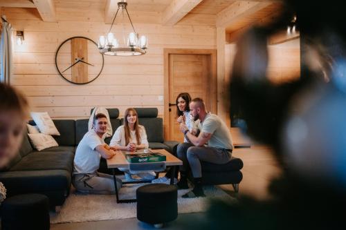 a group of people sitting in a living room at Chata Azarka in Beňuš