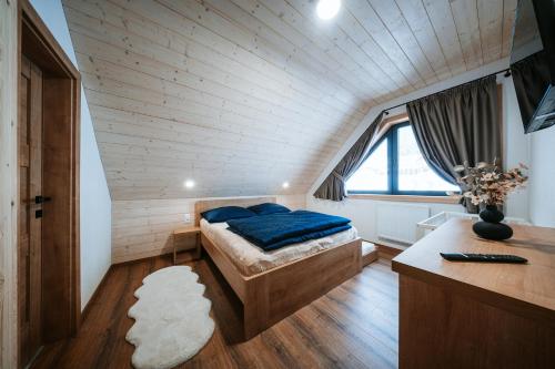 a small bedroom with a bed in a attic at Chata Azarka in Beňuš