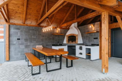 a dining room with a table and a stove at Chata Azarka in Beňuš