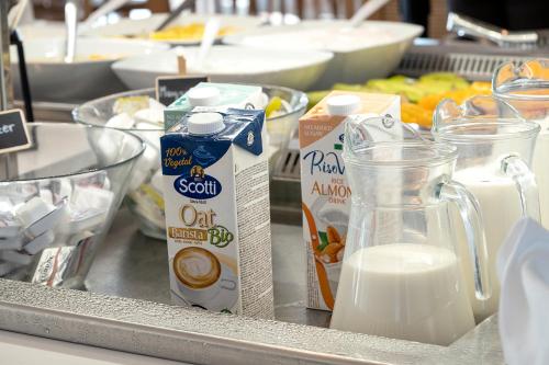 a counter with milk and other food items on it at Maritimo Beach Hotel in Sissi
