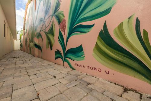 a wall with a mural of flowers on it at LUX 10BR 10BA Pool Beach Front Villa Playa by Bocobay in Oranjestad