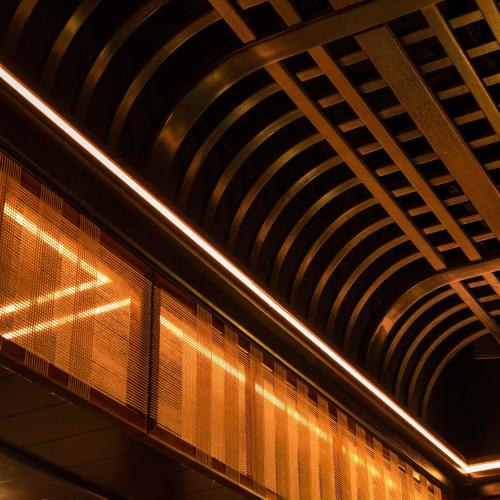 a ceiling of a train station with lights on it at Delano Dubai at Bluewaters in Dubai