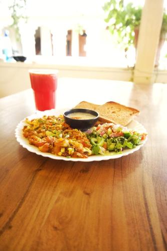 a plate of food on a table with a plate of food at Banana Hostel Pushkar in Pushkar