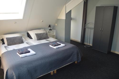 a bedroom with two beds with towels on them at Effe-Zoutelande in Zoutelande