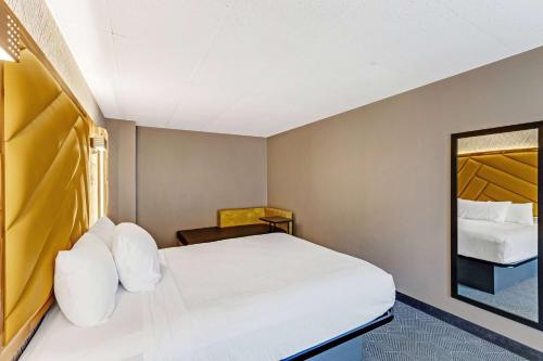 a hotel room with a bed and a chair at The Wander Hotel in Gatlinburg