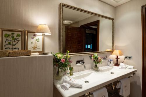 a bathroom with a sink and a mirror at Cigarral del Carmen in Toledo