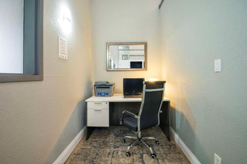 an office with a desk with a computer and a chair at Quality Inn & Suites in Grimsby