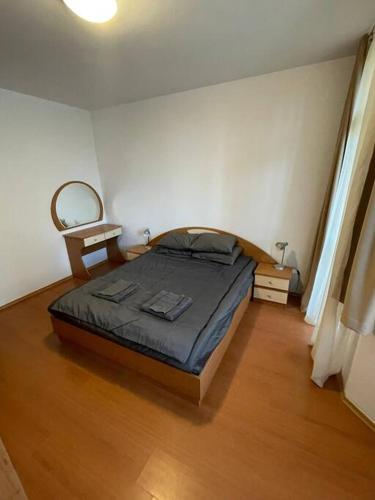a bedroom with a bed and a wooden floor at FLORA Apartment Hotel 412 in Borovets