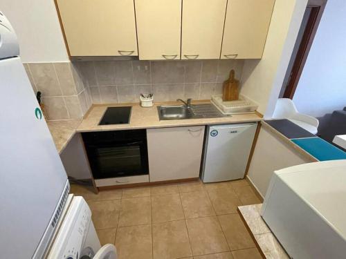 a small kitchen with a sink and a stove at FLORA Apartment Hotel 412 in Borovets
