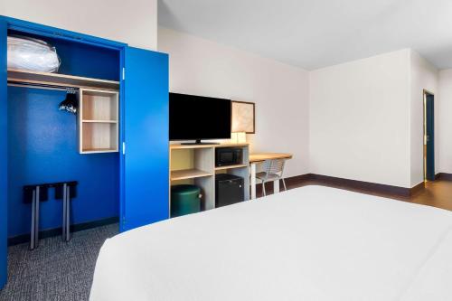 a hotel room with a bed and a tv at Spark by Hilton Pearland in Pearland