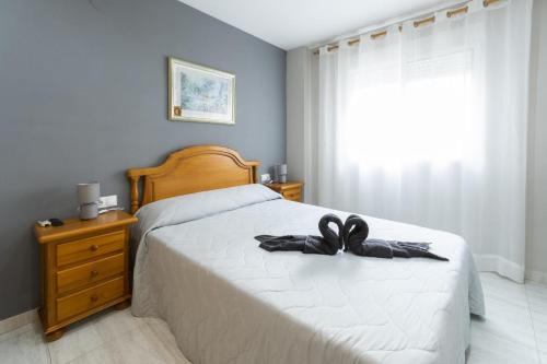 a bedroom with a bed with a black bow on it at Azul in Daimuz