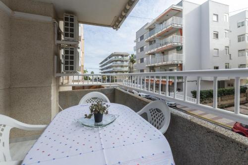 a balcony with a white table and chairs and a building at Azul in Daimuz