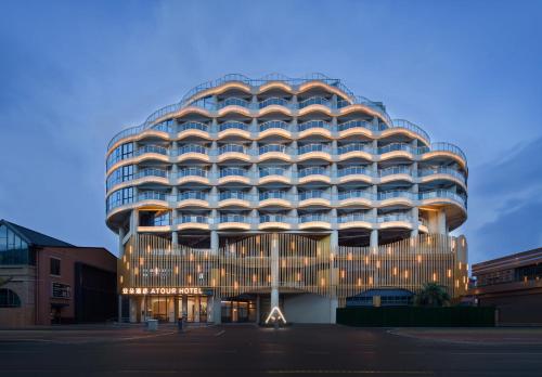 a large building with lights on the side of it at Atour Hotel Haikou Longhua Jinniuling Park in Haikou