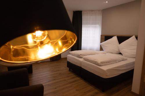 a bedroom with a bed and a table with lights at HLN APARTMENTS Am Bahnhof in Saarbrücken