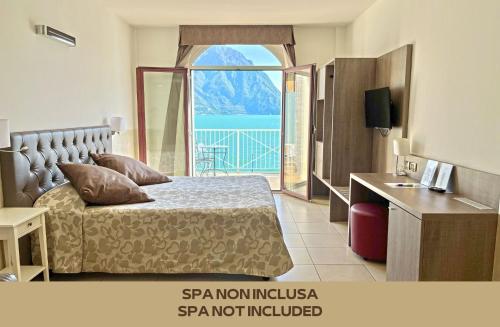 a bedroom with a bed and a large window at Hotel Lovere Resort & Spa in Lovere