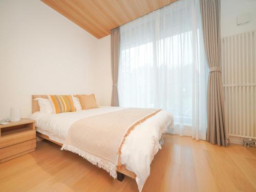Ένα ή περισσότερα κρεβάτια σε δωμάτιο στο Queens Park CK Village Niseko Hirafu