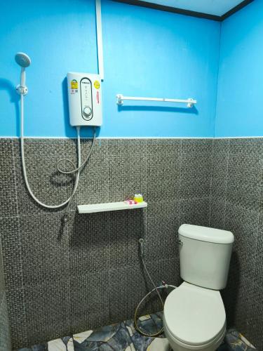 a bathroom with a white toilet and a shower at Boat and House Resort Khao Kho in Khao Kho