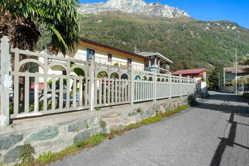 a white fence in front of a building with a mountain at Il Girasole Bed and Breakfast in Donnas