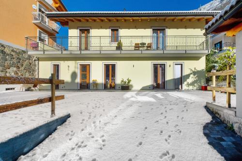 a house with footprints in the snow in front of it at Il Girasole Bed and Breakfast in Donnas