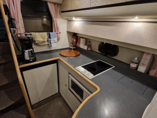 a small kitchen with a sink and a stove at Prinsessan i Lilla Bommen in Gothenburg