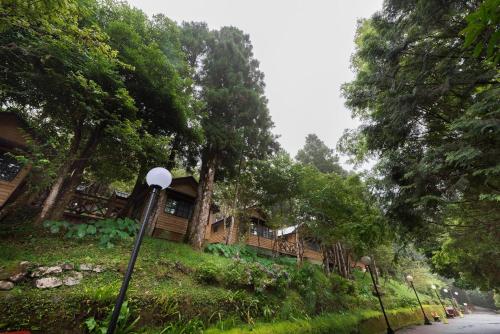 a house on the side of a road with trees at Ming Chi Resort in Datong