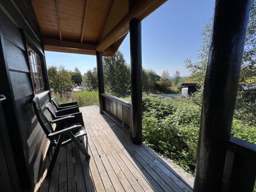 a porch with two benches sitting on a house at Nostalgic Cabin with 3 BR, Fireplace, and Terrace in Beitostøl