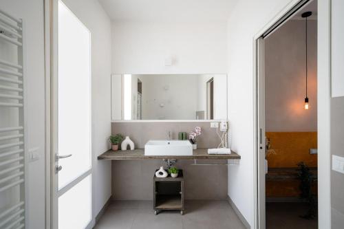 a bathroom with a sink and a mirror at Club del Sole Le Mimose Family Resort in Porto SantʼElpidio