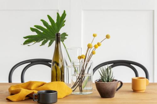 a wooden table with two chairs and a vase with flowers at voco London Marylebone by IHG in London