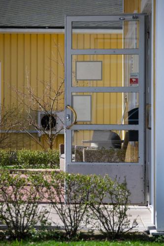an open door of a house with a dog behind it at Hotel Sea Front in Tammisaari