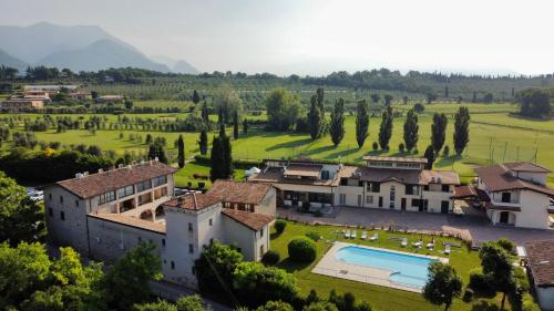 an aerial view of a mansion with a swimming pool at Il Colombaro in Salò