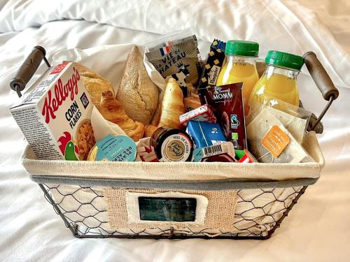 a basket filled with food and drinks on a bed at Aparthotel AMMI Nice Lafayette in Nice