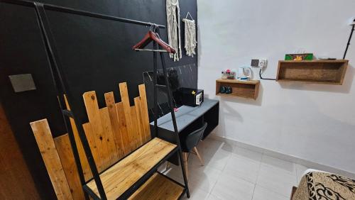 a room with a wooden bench and a blackboard at Suba Homestay in Nusa Lembongan