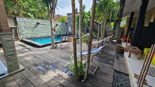 a patio with a swimming pool and trees at Suba Homestay in Nusa Lembongan