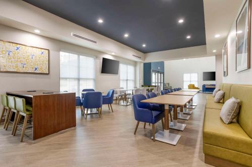 una sala d'attesa con tavoli e sedie blu di Comfort Inn & Suites Huntsville Near University a Huntsville