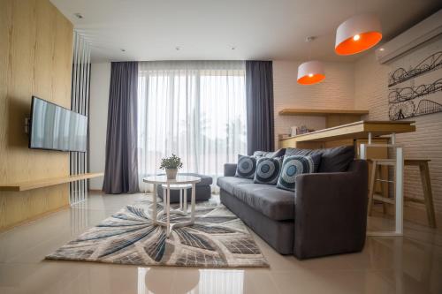 a living room with a couch and a table at The Bliss Ubon in Ubon Ratchathani