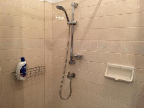 a bathroom with a shower with a toilet and a sink at 42 Guest House in Bangkok