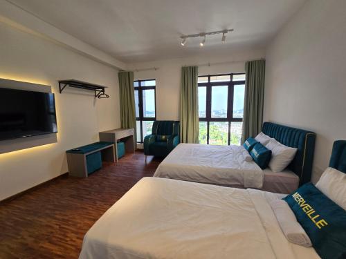 a hotel room with two beds and a flat screen tv at K Avenue Kota Kinabalu by Merveille - Sabah in Donggongon