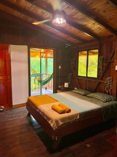 a bedroom with a bed in a room with windows at Sky and Sand in Bahía Solano