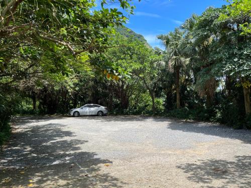 a car parked in the middle of a road with trees at Adagio JinGuaShi in Jiufen