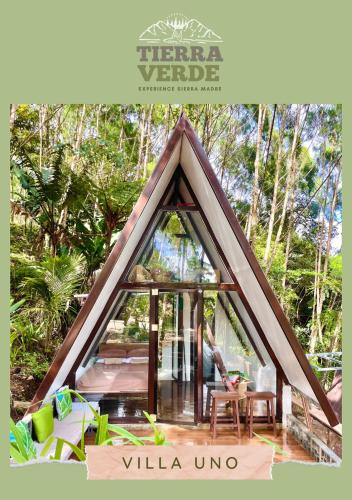 a room in a triangle shaped house with a window at Tierra Verde Villas in Quelalag