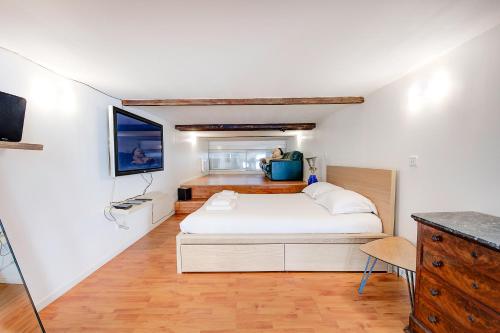 une chambre avec un lit blanc dans une pièce dans l'établissement Loft atypique avec bowling pour 12 voyageurs, cabinet des curiosités, à La Riche