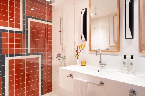 a bathroom with a sink and a shower at Kimpton Los Monteros Marbella by IHG in Marbella