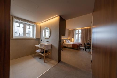 a hotel room with a bed and a bathroom at Templo Hotel & SPA in Braga