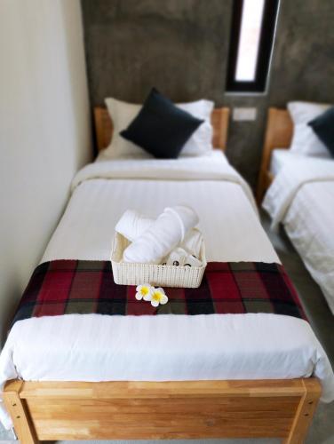 a bedroom with two beds with towels on a blanket at Silvan Garden Cameron Highlands in Tanah Rata