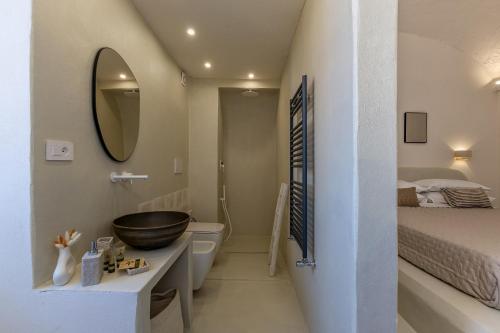 a bathroom with a sink and a toilet and a bed at Casa Tua - Countryhouse- in Sorrento