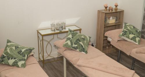 a living room with two couches and a table at ANEW Resort Hunters Rest Rustenburg in Rustenburg