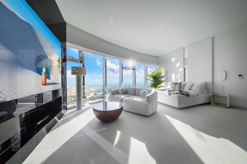 a living room with a couch and a large window at Sky Tower - 48 Piętro Penthousy z Prywatna SPA - ADULT ONLY in Wrocław